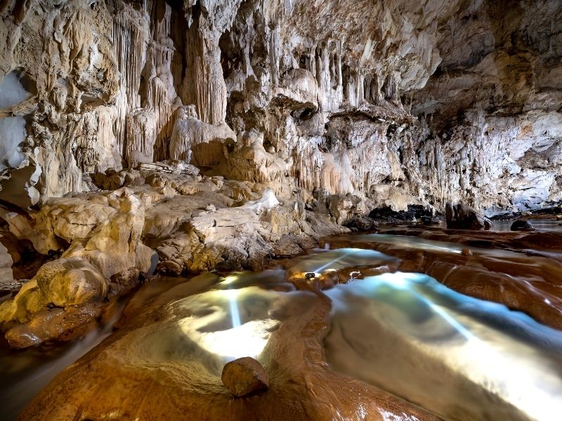 magickal grey and brown and yellow caves with pools of turquoise water